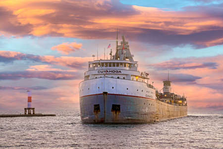 Cuyahoga freighter entering Holland Harbor in Holland Michigan at sunset timeのeditorial素材