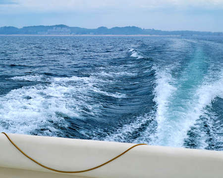 Boat wake behind powerboat on Lake Michigan
