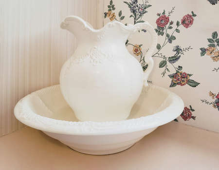 Vintage ivory bowl and pitcher with retro wallpaper backgroundの写真素材