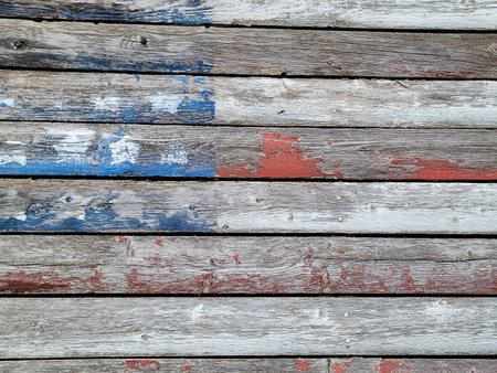 Faded American flag painted on rustic weathered woodの写真素材