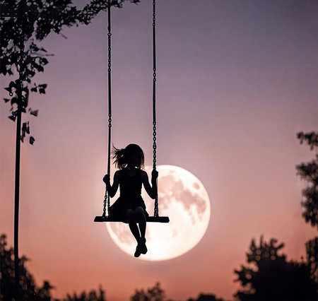 Girl on a swing silhouette with a full moon in the pink skyの素材