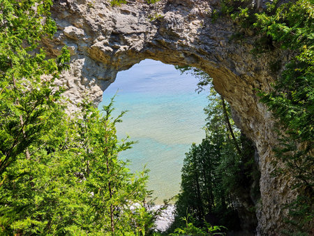 Arch Rock on Mackinac Island in Michigan with aqua water summer green treesの写真素材