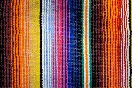 Traditional woven Mexican blanket with colorful vertical striped patternの写真素材