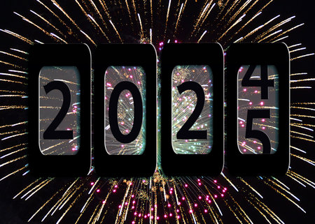 Bold number "2025" is displayed on a black odometer on fireworks in the black sky as the year changesの写真素材