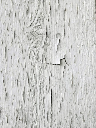 Cracked and peeling paint covers the surface revealing weathered wood underneathの写真素材