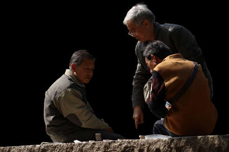 seniors playing chinese chess in park