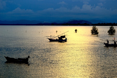 fishing shore boat and the sun falls , の写真素材