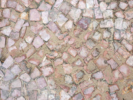 old stone masonry is dirty with wet sand