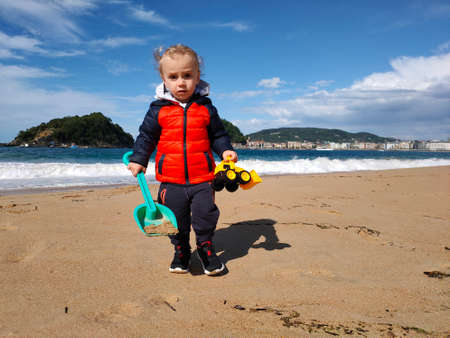 child playing on the beach in the off seasonの写真素材