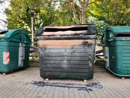 burnt out trash can on the streetの写真素材