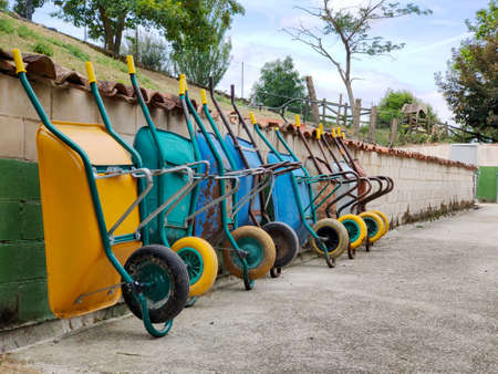 many garden carts supported on the wallの写真素材