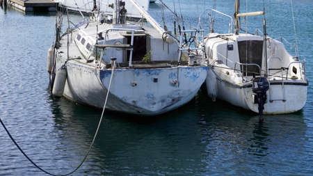 old abandoned yacht overgrown with grassの写真素材