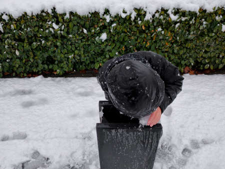 the boy drinks ice water, in the cold winter seasonの写真素材