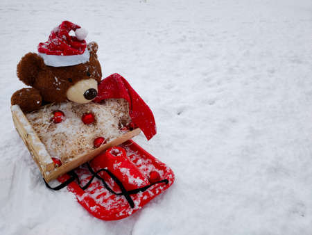 teddy bear sledding with toys on the christmas treeの写真素材