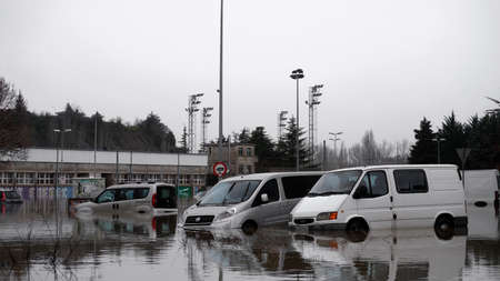 As the water recedes after a flood, drowning cars are seen in a parking lot in Pamplona, ââSpain, December 12, 2021.のeditorial素材