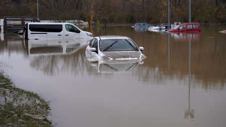 dirty car floats in the river, flood of the Arga river in the city of Pamplona, ââSpain December 12, 2021のeditorial素材