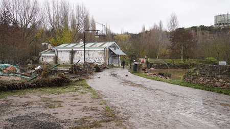 the consequences of flooding in the city of Pamplona, ââthe river broke the fence of a private building. December 12, 2021のeditorial素材