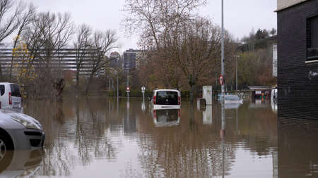 a car in a city parking lot floats in the water due to severe flooding Pamplona city Spain 12 December 2021のeditorial素材