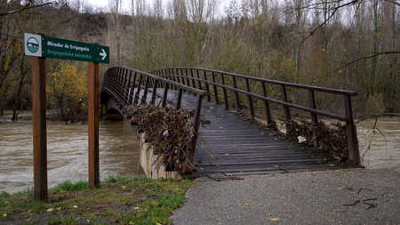 wooden bridge damaged by floods. Pamplona, ââ11 December 2021のeditorial素材