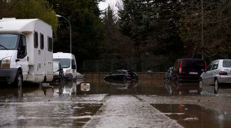 woman in rubber boots overcomes an obstacle on the bridge. Pamplona, ââNavarra, 11 December 2021のeditorial素材