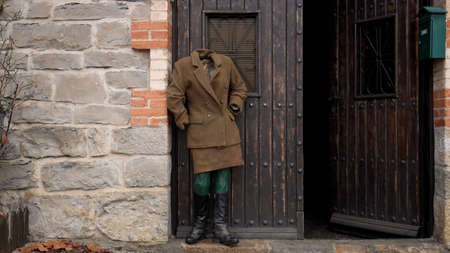 mannequin, with old clothes, stands at the door of a stone house. Pamplona, ââDecember 11, 2021のeditorial素材
