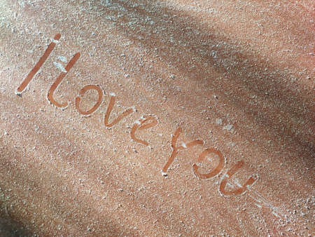 inscription: I love you! on a dusty wooden surfaceの写真素材
