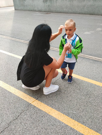 a small child came to school for the first time, together with his mother. first day of schoolの写真素材