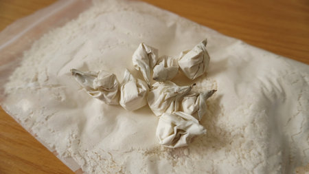 package with white powder, packaging by doses