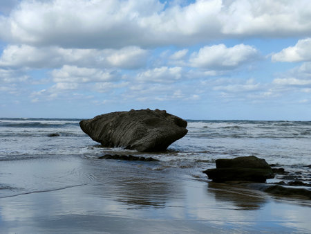 stone reefs against the blue sky at low tide on the oceanの写真素材