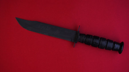 American military combat knife on a red backgroundの写真素材
