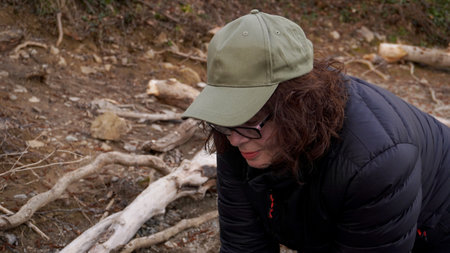 red-haired woman in glasses and a cap, in the forestの写真素材