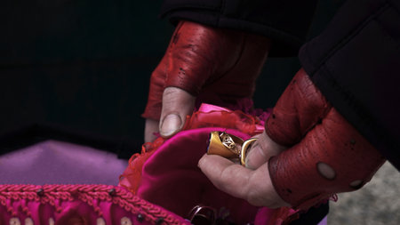 a poor woman in search of food in a dumpster finds discarded gold items by someoneの写真素材