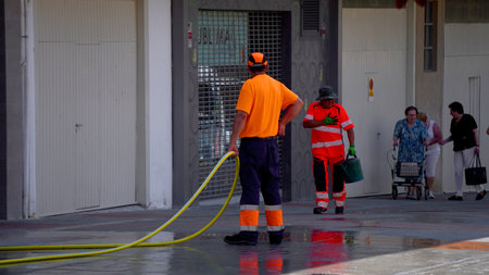 a cleaning man clutching his left chest, due to possible heart pain, at the Mutilva (Navarra) festivities on June 25, 2023のeditorial素材