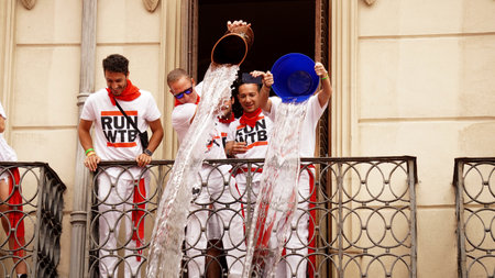 people pour water from the balcony in honor of the opening of the holiday: San Fermin. city ââ: Pamplona (Navarra) EspaÃ±a .6 de julio 2023aÃ±oのeditorial素材