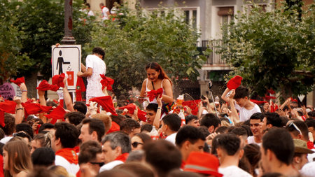 people douse themselves with wine in honor of the opening of the holiday: San Fermin. city ââ: Pamplona (Navarra) EspaÃ±a .6 de julio 2023aÃ±oのeditorial素材