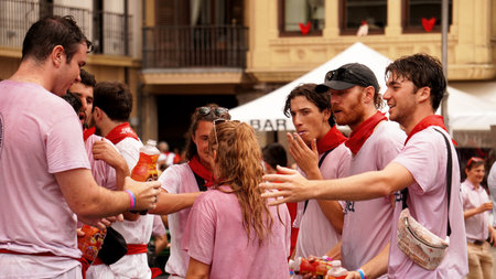 a group of friends drenched in wine after the opening of the festivities: San Fermin. Castle Square. July 6 Pamplona. Spain. year 2023のeditorial素材