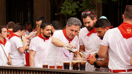 a group of men drinking alcohol in the street in the celebration of San Fermin. Pamplona (Navara) July 6, 2023のeditorial素材