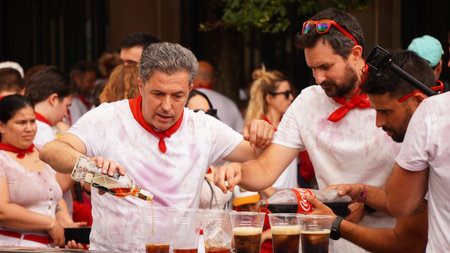 a group of men drinking alcohol in the street in the celebration of San Fermin. Pamplona (Navara) July 6, 2023のeditorial素材