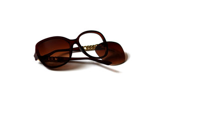 broken sunglasses, brown color, white backgroundの写真素材