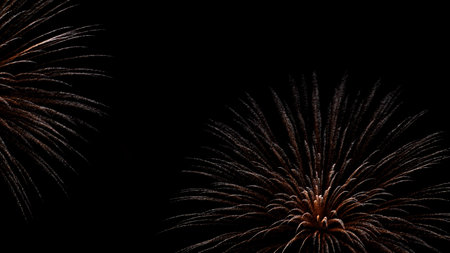 fireworkscard. Beautiful fireworks, red-orange in color. Isolated on black background. Christmas card, New Year holidaysの写真素材