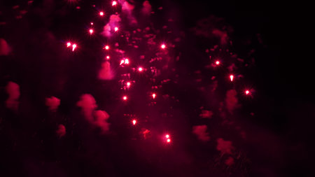 black background with fireworks shots in raspberry colorの写真素材