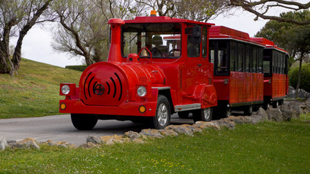 Red locomotive summer attraction for children, in a park.
