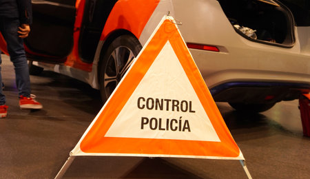Close-up of a portable road sign, with the inscription in Spanish: police check! concept: monitoring...