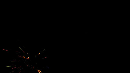 black background with a blot in the form of fireworks splashes, different colors, in the lower left cornerの写真素材