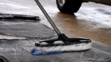 Cleaning carpets from car interiors with a brush and soapの写真素材