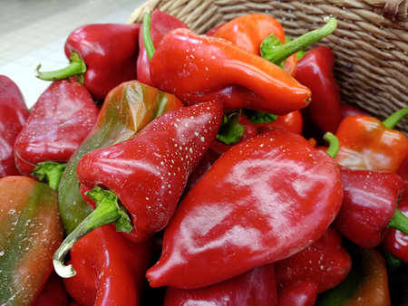 straw baskets filled with freshly picked red peppersの写真素材