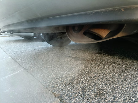 a car exhaust pipe with white smoke coming out of itの写真素材