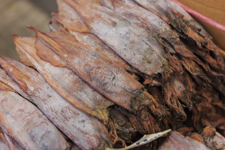 Dried Squid, traditional squids drying in the sun in a market Thailandの写真素材