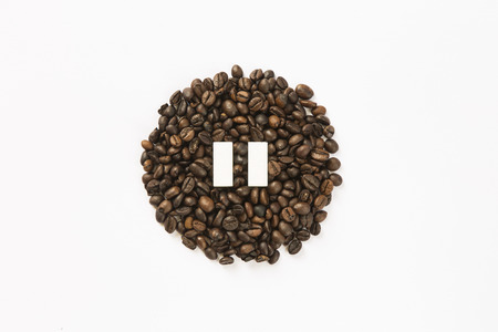 coffee beans arranged in a circle with pause sign