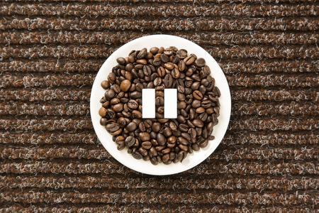 coffee beans arranged in a circle with pause sign